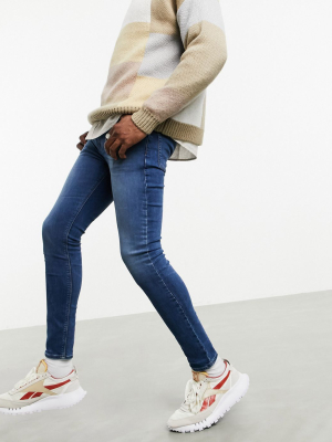 Asos Design 'responsible Edit' Spray On Jeans In Power Stretch In Mid Blue